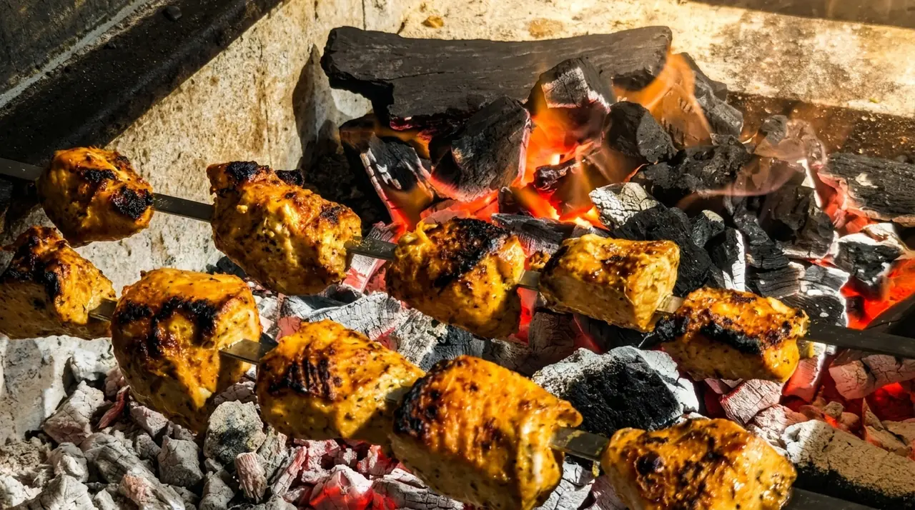 Chicken kebab skewers over live charcoal